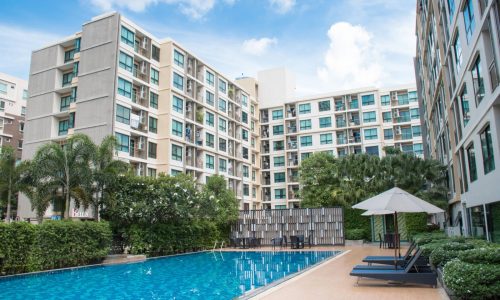 8-storey residential condo building with a swimming pool in the middle of the building.